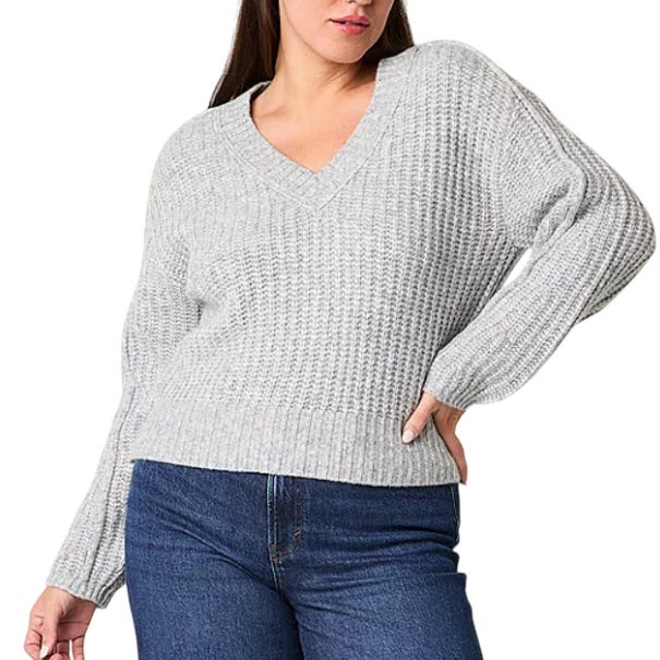 Gray V-neck knit sweater paired with dark blue jeans.