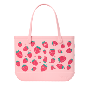Pink tote bag with strawberry pattern and \“bogg\“ embossed on the lower front.