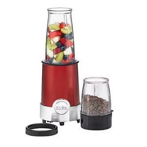Red blender with two containers filled with fruit and coffee beans, featuring a silver base and black lids.
