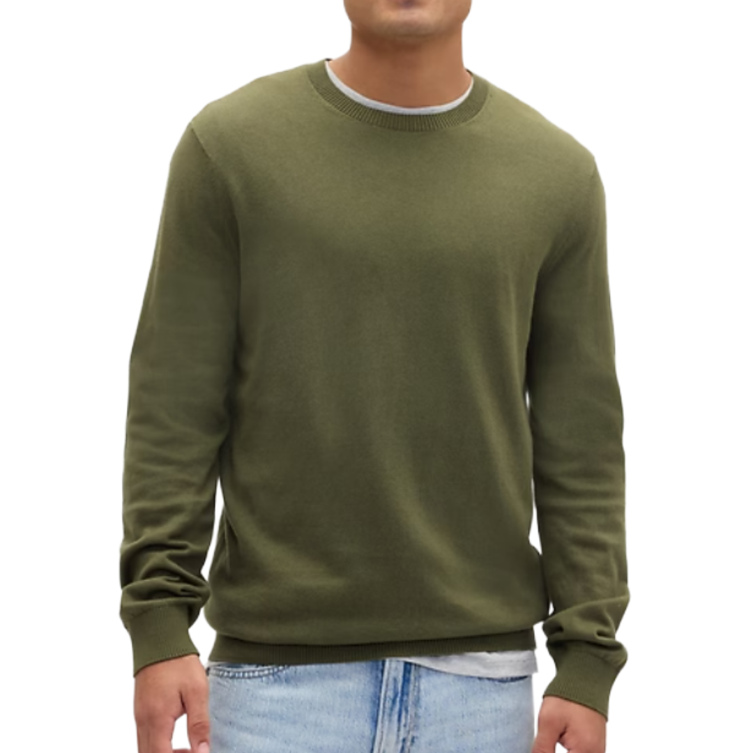 A person is wearing a plain olive green sweater with long sleeves paired with light blue jeans.