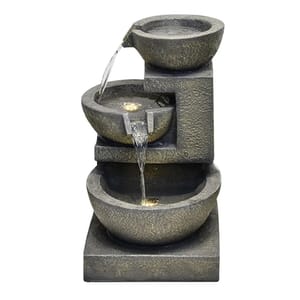 A tiered tabletop fountain with three bowls featuring flowing water illuminated by LED lights. The design showcases a minimalist and rustic stone-like texture.