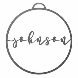 A round metal ornament features the name \“Johnson\“ in cursive script, centered within the circle, with a small loop at the top for hanging.
