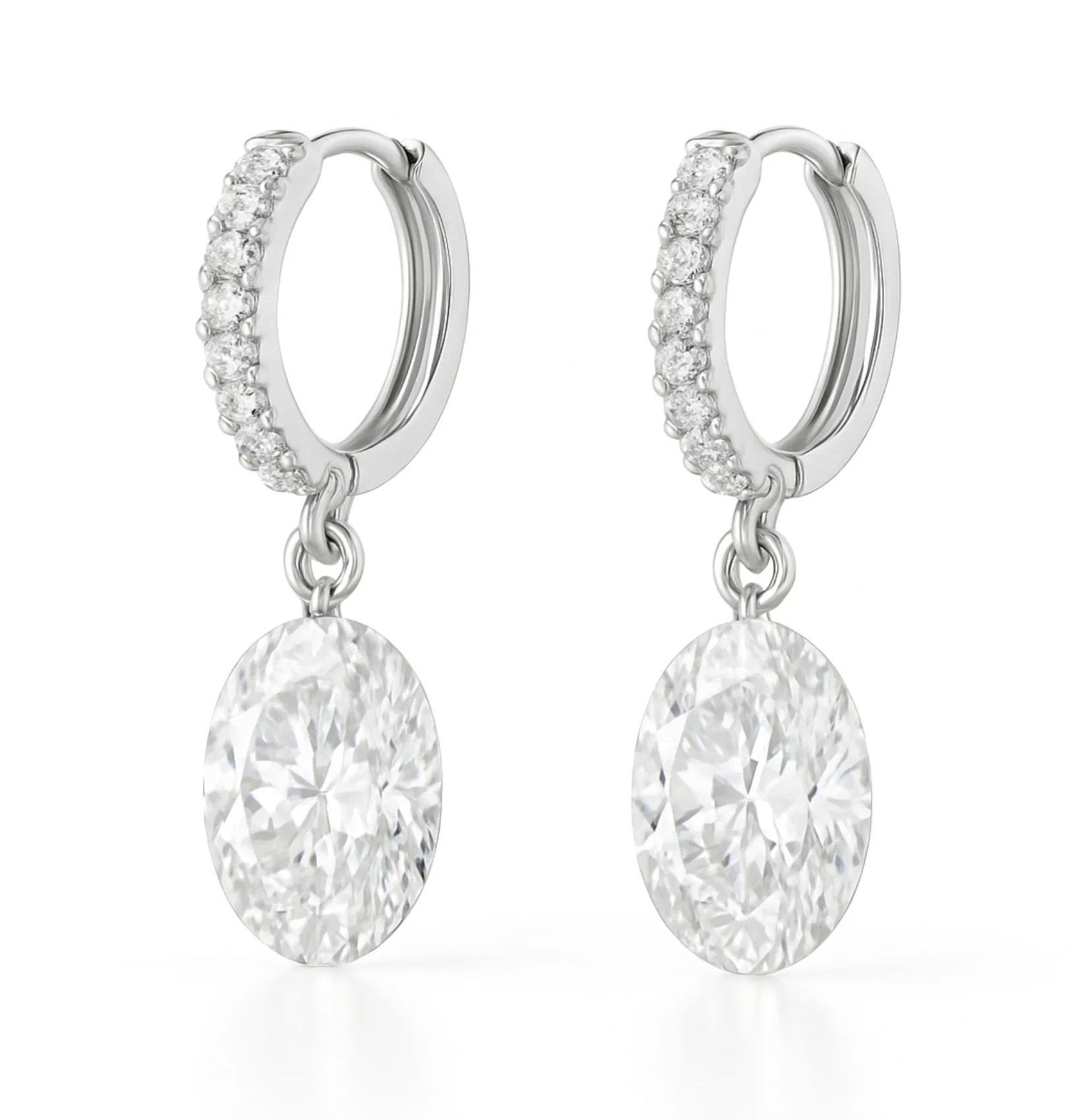 Elegant silver hoop earrings adorned with small diamonds, featuring large oval-cut diamond pendants.