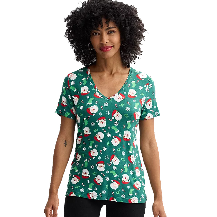 A green V-neck T-shirt with a festive Christmas pattern featuring Santa Claus faces, candy canes, snowflakes, and holly.