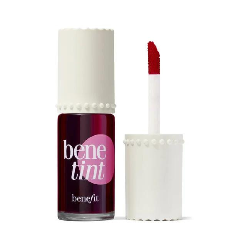 A bottle of BeneTint lip and cheek stain by Benefit Cosmetics with a white cap and applicator brush, featuring a dark red liquid tint.