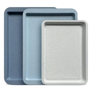 Three stackable rectangular baking trays in different shades of blue and gray with a speckled pattern.