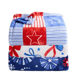 A folded fleece blanket with red, white, and blue patterns featuring stars, stripes, and bows.