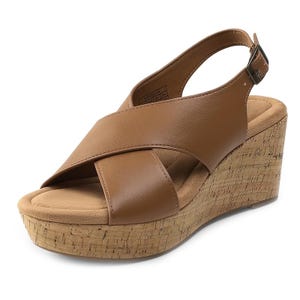 Brown wedge sandals with wide crisscross straps, an adjustable buckle closure, and a cork-textured platform heel.