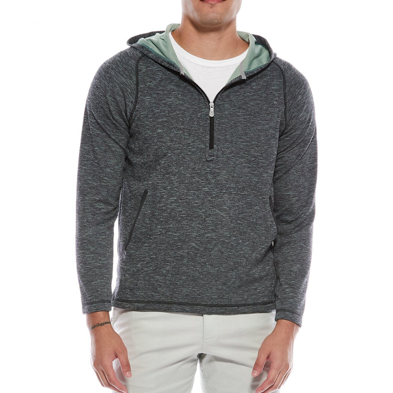 A man is wearing a gray zip-up hoodie with a light green lining, paired with white pants.