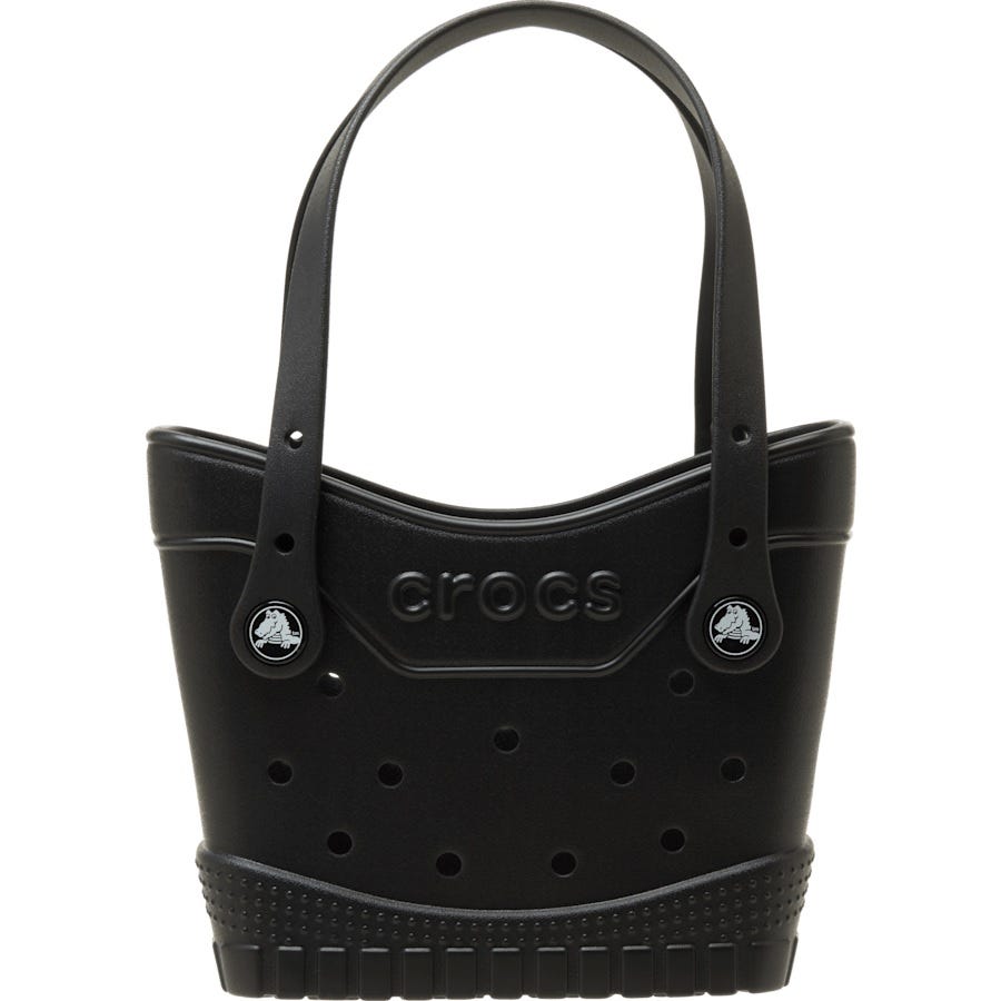 A black Crocs handbag resembling a classic Crocs shoe with perforated design, featuring logo details and two handles.