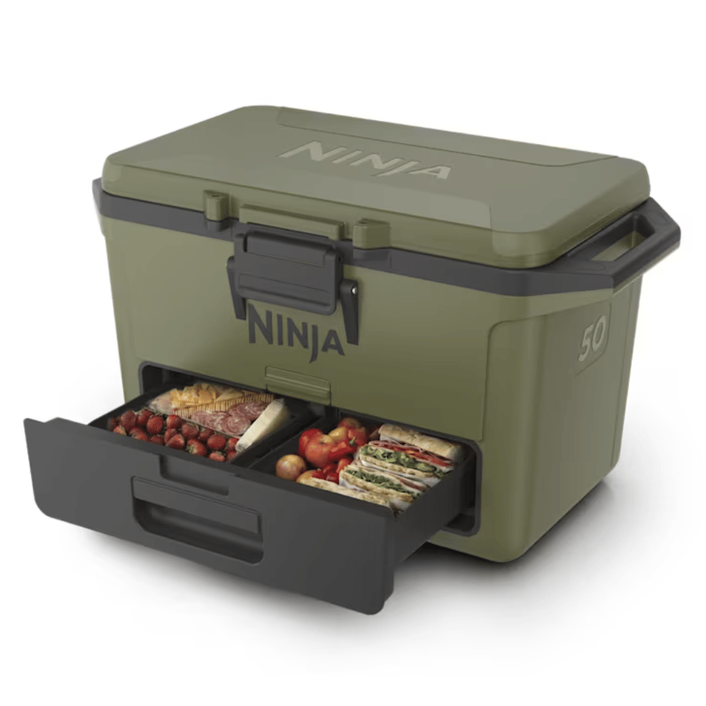 A green Ninja cooler with a pull-out drawer containing food items like strawberries, sandwiches, and tomatoes.