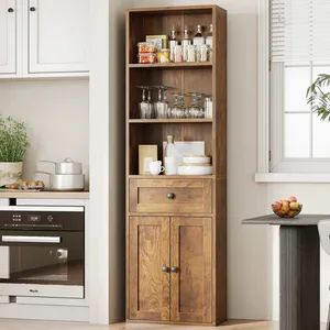 Tall wooden cabinet with upper open shelves displaying glassware and jars, a middle drawer, and lower closed storage. The setting includes a kitchen oven, a potted plant, and fruit bowl on a nearby table.