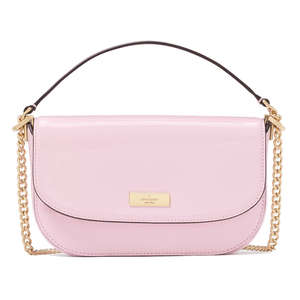 A pastel pink shoulder bag with a glossy finish, gold chain accents, and a flap closure featuring a small gold brand plaque.
