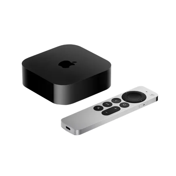 An Apple TV box next to its remote control.