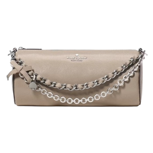 A beige Kate Spade New York clutch bag featuring a chain handle with a ribbon and charm detail.