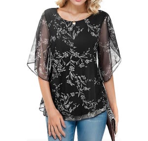 Black chiffon blouse with floral print, featuring flutter sleeves and a round neckline, paired with light blue jeans. The blouse has a semi-sheer outer layer with an opaque lining.