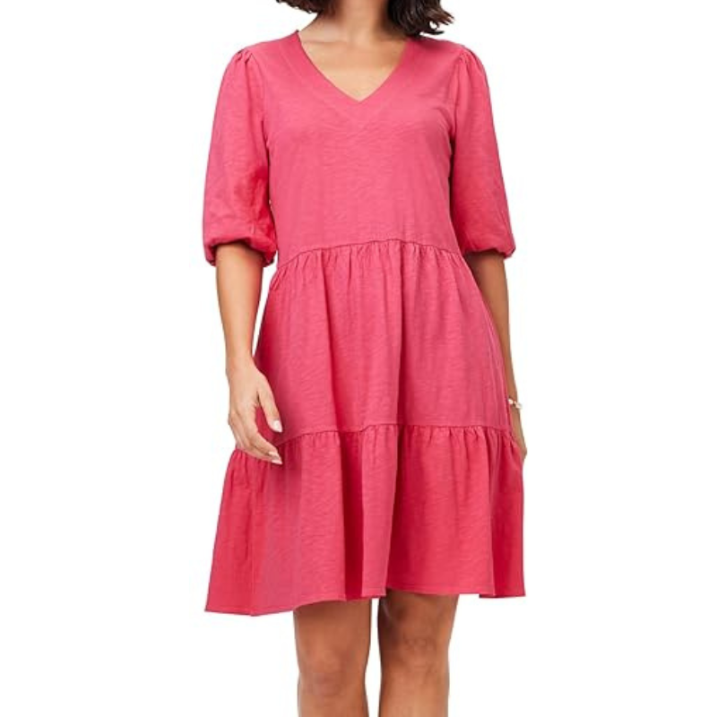 A pink, tiered knee-length dress with a V-neck and elbow-length puff sleeves, offering a casual and flowing fit. The fabric has a subtle texture, adding visual interest.