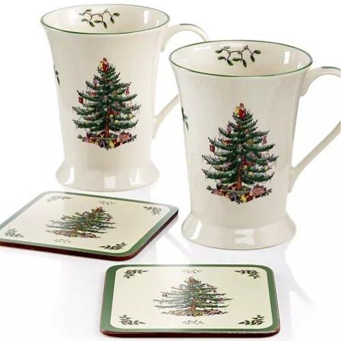 Two ceramic mugs and two coasters, each featuring a Christmas tree design with green borders and mistletoe accents.