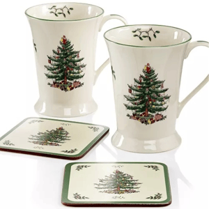 Two ceramic mugs and two coasters, each featuring a Christmas tree design with green borders and mistletoe accents.