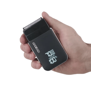 A hand holding an electric shaver featuring an LED display showing battery level and usage time.