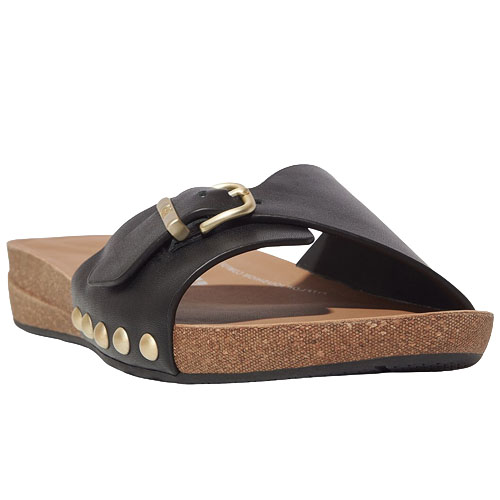 A black slide sandal with a low wedge heel features gold-tone studs and a buckle on the strap.