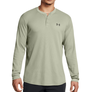 A light green Under Armour long sleeve Henley shirt featuring a buttoned neckline and the brand logo on the chest.