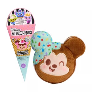 A plush in the shape of Mickey Mouse's head with one ear featuring colorful spots is presented next to packaging resembling an ice cream cone, both branded with Disney Munchlings.