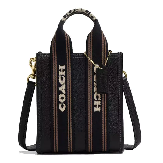 Coach black leather tote bag with wide fabric handles featuring the brand's name, detachable shoulder strap, and gold-tone hardware.