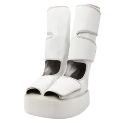 White, knee-high platform shoes with a futuristic design, featuring open toes and large Velcro straps.