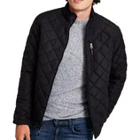 A black quilted jacket with a front zipper and zippered chest pocket, worn over a gray sweater and paired with blue jeans.