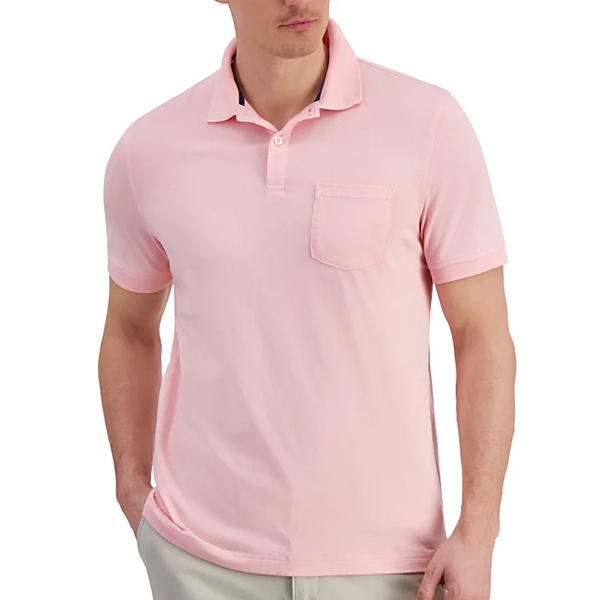 A man is wearing a light pink polo shirt with a pocket on the left chest, paired with light-colored pants.