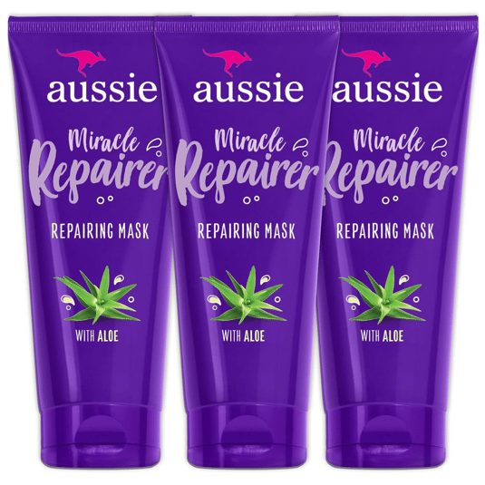 Three tubes of Aussie Miracle Repairer Repairing Mask with Aloe, packaged in a purple design featuring an aloe plant graphic.