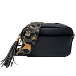 A black crossbody bag with a decorative leopard-print strap and a tassel accent.