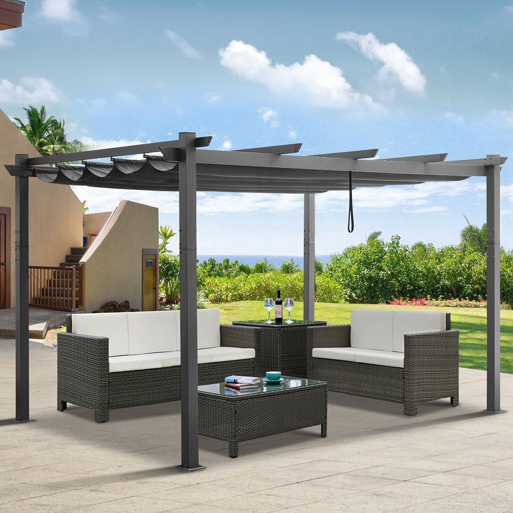 Outdoor patio set with a pergola, featuring two cushioned sofas, a matching armchair, a central coffee table with a glass top, and a side table, all in a woven rattan design.