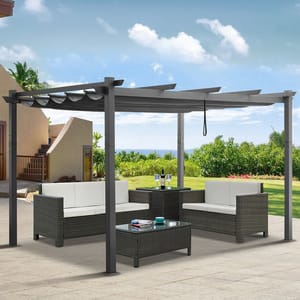 Outdoor patio set with a pergola, featuring two cushioned sofas, a matching armchair, a central coffee table with a glass top, and a side table, all in a woven rattan design.