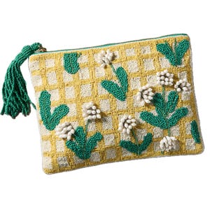 Beaded clutch with floral pattern, featuring yellow grid background, green leaves, white flowers, and a green beaded tassel zipper pull.