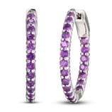 Silver hoop earrings adorned with round purple gemstones.