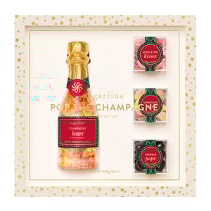 Sugarfina \“Pop the Champagne\“ Candy Gift Set includes a champagne bottle-shaped container of Champagne Bears and three small boxes of Mistletoe Kisses, Sparkling Bubbly Bears, and Sparkle Pops, all elegantly packaged in a festive gift box.