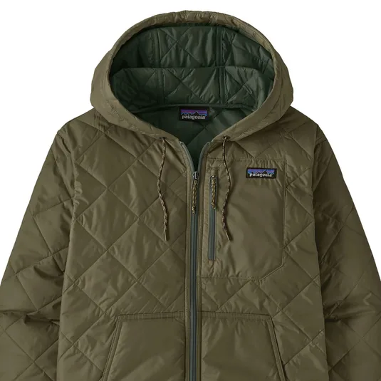 A khaki-colored quilted jacket with a hood, featuring a front zipper, chest pocket, and a small embroidered logo on the left chest.