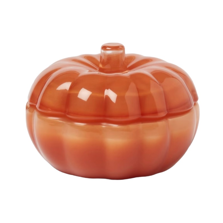 Orange ceramic pumpkin-shaped container with a lid, featuring a glossy finish.