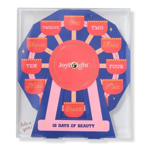 A \“JoyBright 12 Days of Beauty\“ set designed like a Ferris wheel features numbered compartments one to twelve for beauty products.