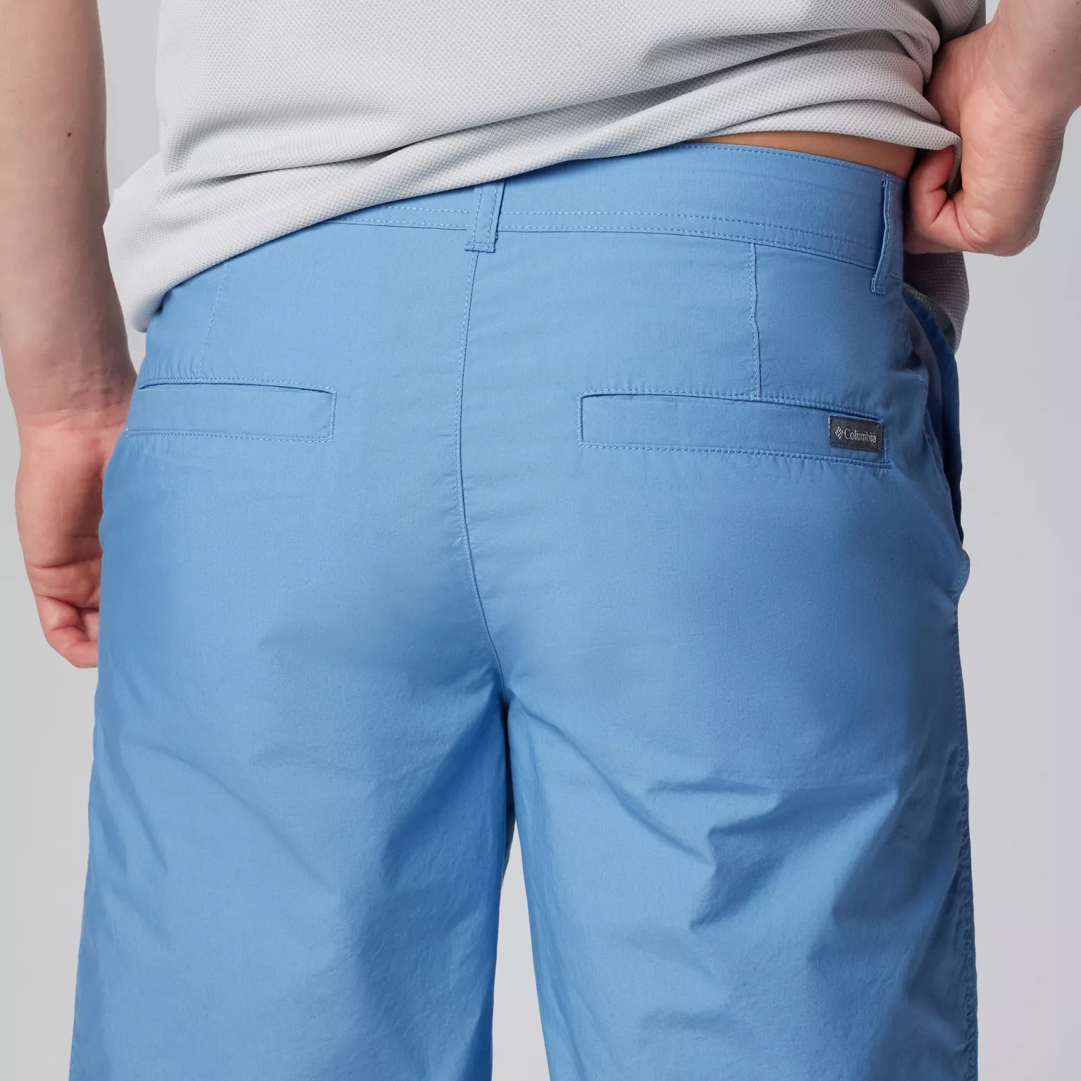 Light blue pants with back pockets and a small logo label on the right side.