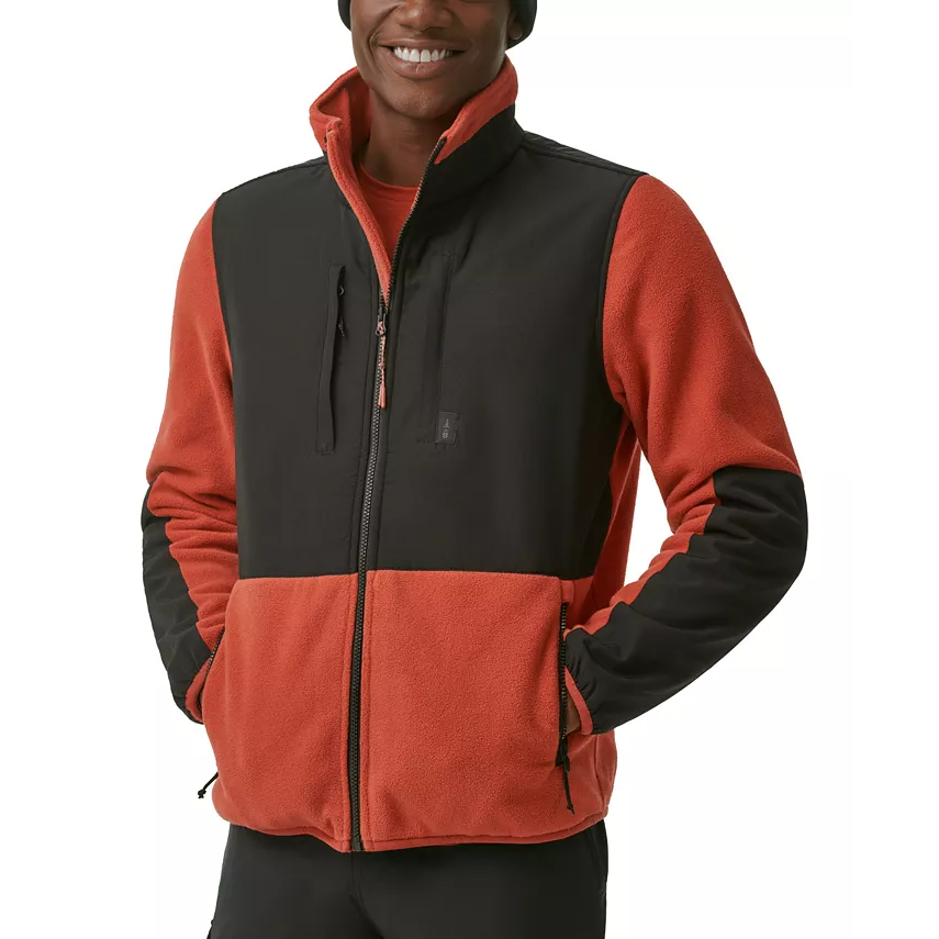 A man wearing a two-tone fleece jacket with a full zipper and side pockets.