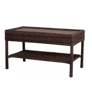 A brown wicker outdoor coffee table with a lower shelf for additional storage.
