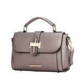 A taupe leather handbag with a top handle, gold-tone hardware, a flap closure with a decorative buckle, and an optional shoulder strap.