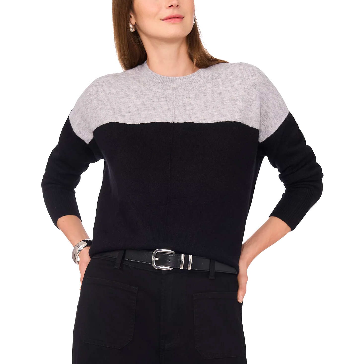 Color-block sweater in black and gray, paired with black pants and a black belt with a silver buckle.