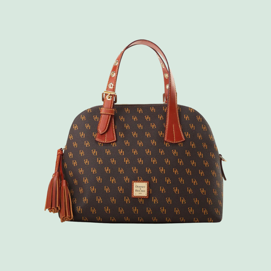 Dooney & Bourke satchel with a brown monogram pattern and contrasting leather handles and tassel.