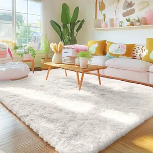 A cozy living room features a soft, white, fluffy rug, a wooden coffee table with plants and books, a pink couch adorned with colorful pillows, and a large potted plant by a bright window.