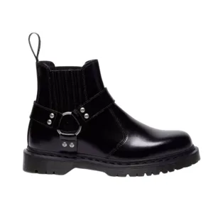 A black leather ankle boot with a chunky sole and harness strap detailing, featuring elastic side panels and a pull tab for easy wear.