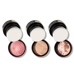 Three Laura Geller makeup items, consisting of a pink blush, a neutral highlighter, and a marbled bronzer, are displayed with open lids.